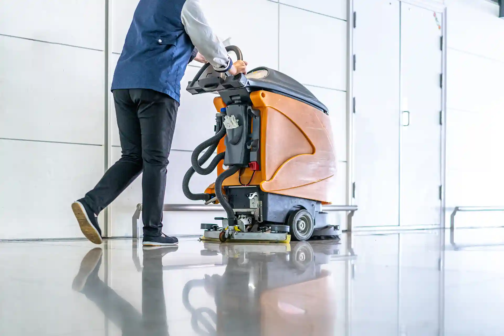 Cleaning hard floor with a machine.